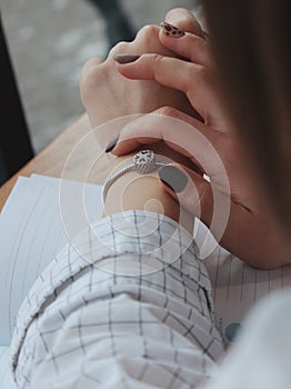 Female with a fashionable silver bracelet with a pendant