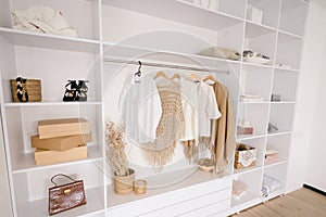 Female Fashionable Stylish Wardrobe. A Large White Built-in Wardrobe Stocked With Women's Clothing, Shoes and