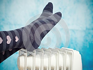 Female feet above the heater.