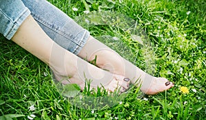 female feet barefoot on green grass