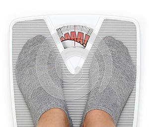 Female feet on bathroom scale