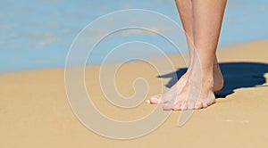 Female feet on the beach