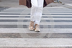 female feet on a crosswalk