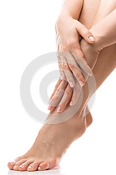 Female feet and hands with soft skin, french manicure and pedicure on white background