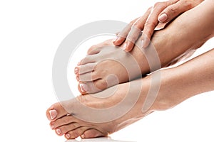 Female feet and hands with soft skin, french manicure and pedicure on white background