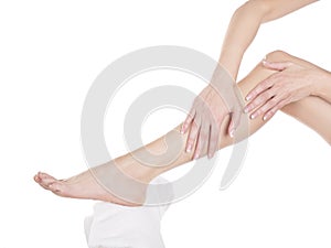 Female feet leg cream on white background isolation