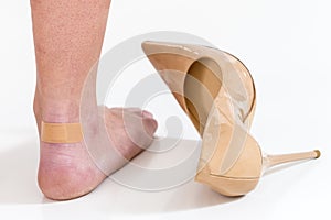 female feet in pain after wearing high heeled shoes