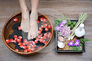 Female feet at spa pedicure procedure, Closeup photo of a female feet at spa salon on pedicure procedure. Female legs in water de