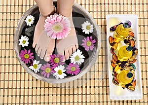 Female feet at spa salon on pedicure procedure