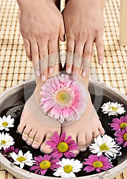 Female feet at spa salon on pedicure procedure