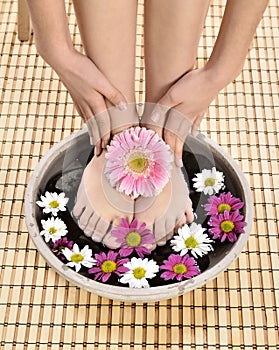 Female feet at spa salon on pedicure procedure