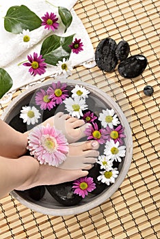 Female feet at spa salon on pedicure procedure