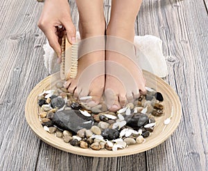 Female feet at spa salon on pedicure procedure