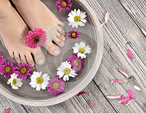 Female feet at spa salon on pedicure procedure