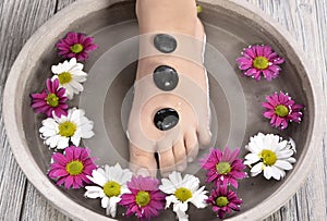 Female feet at spa salon on pedicure procedure