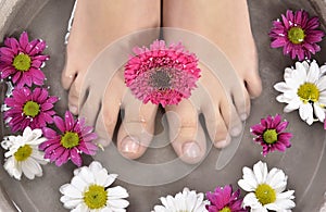 Female feet at spa salon on pedicure procedure