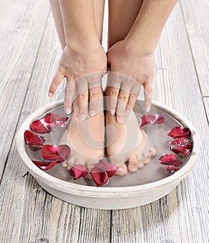 Female feet at spa salon on pedicure procedure