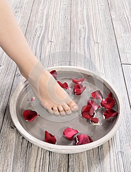 Female feet at spa salon on pedicure procedure