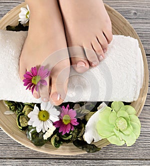 Female feet at spa salon on pedicure procedure