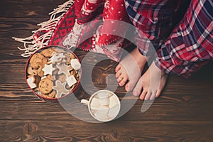 Female Feet Wearing Cozy Warm Pajamas Pants Jar with Gingerbread Cookies Cup of Hot Cococa with Marshmellow Cozy Christmas Concept