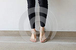 Female feet wearing slippers or flip-flop outdoor red nail