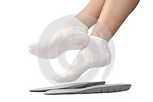 Female feets in white socks and insoles isolated on a white background. A set of different photos for design