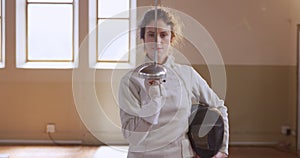 Female fencer athlete during a fencing training in a gym