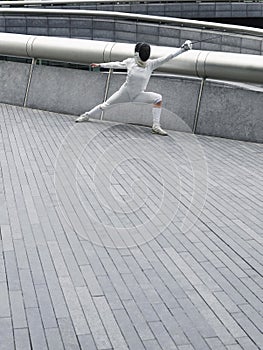 Female Fencer Lunging Outdoors
