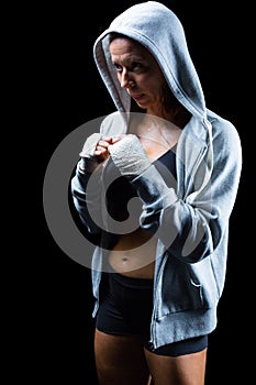 Female fighter in hood with fighting stance