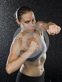Female Fighter in Punching Pose Looking Aggressive