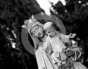 Female figure with crown holding a child