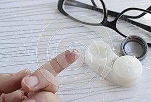 Female finger with contact lens