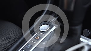 Female finger presses car start button