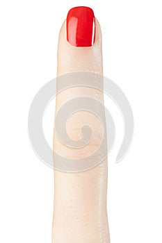 Female finger with red nail polish manicure