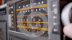 Female Fingers Adjusting the Frequency on an Old Vintage Analog Receiver