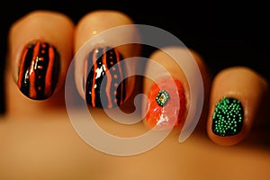Female fingers with beautiful art manicure. Nail art with abstract design. Black background