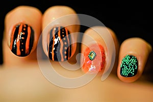 Female fingers with beautiful art manicure. Nail art with abstract design. Black background