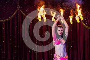Female Fire Dancer Twirling Flaming Apparatus