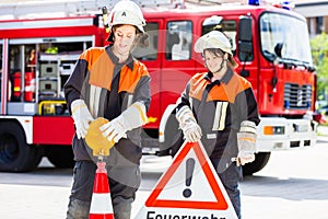 Female fire fighters setting up attention sign