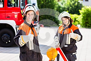 Female fire fighters setting up attention sign photo