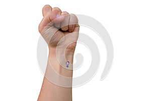 Female fist on a white background with a female symbol painted on her wrist