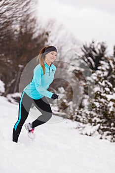 Female fitness sport model outdoor in cold winter weather