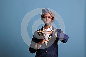 Female flight attendant making time-out gesture