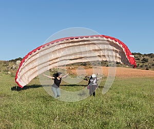 Female flight instructor, teaching a woman to take off with a paraglider