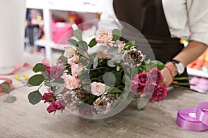 Female florist with bouquet of beautiful flowers