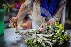 Female florist trimming flower stem