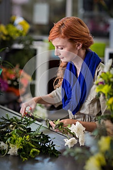 Female florist trimming flower stem