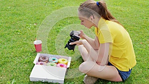 Female food photographer shooting donuts on grass