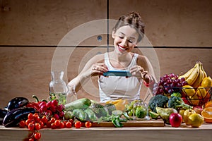 Female food photographer with smartphone