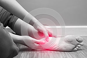 Female foot heel pain with red spot, plantar fasciitis